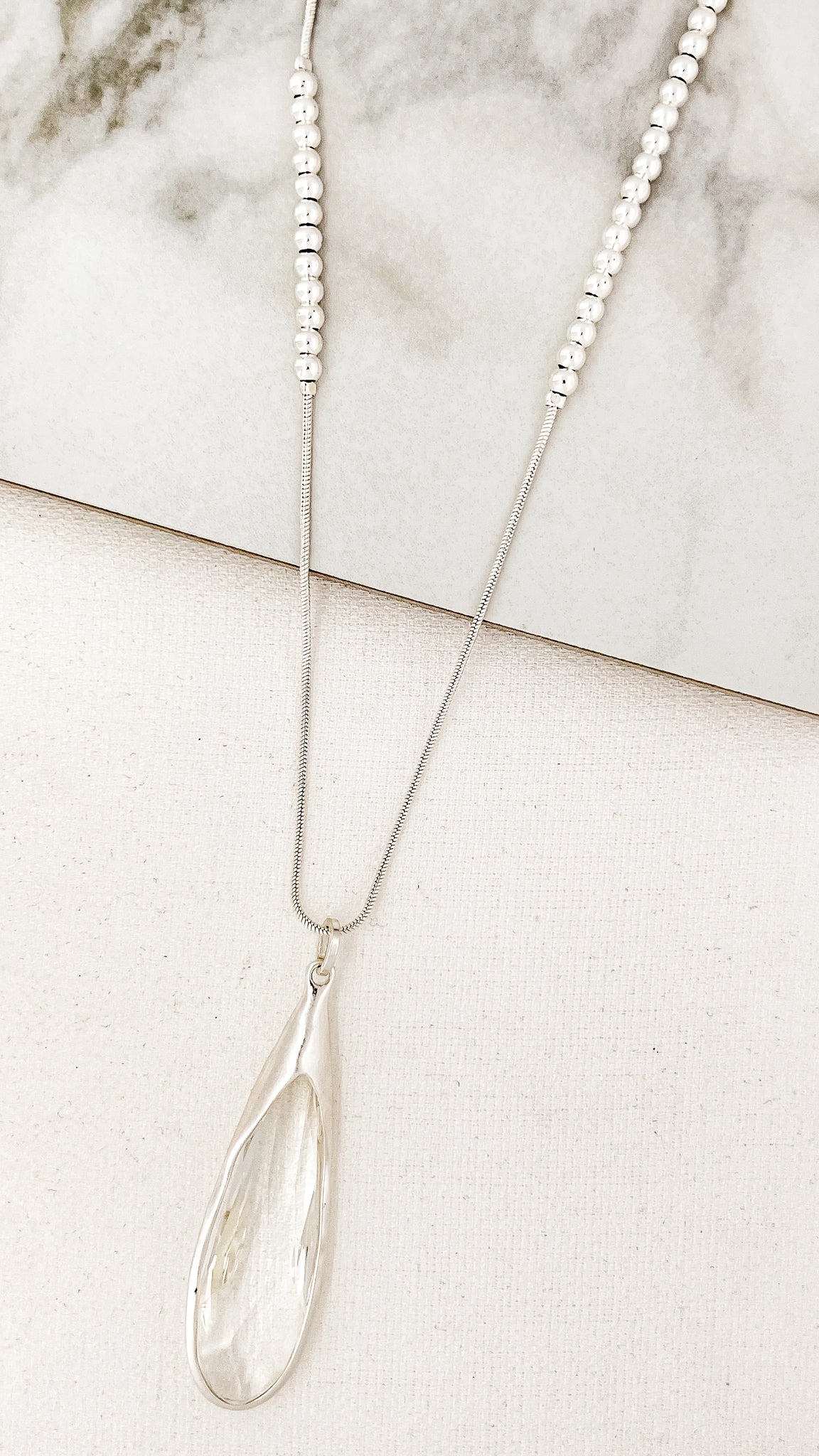 Long silver necklace with smokey grey drop glass pendant