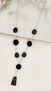 Short silver necklace with black and grey resin circles